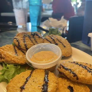 Fried green tomatoes drizzled with balsamic dressing