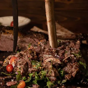 a steak on a cutting board with a knife