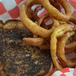 a grilled sandwich and onion rings