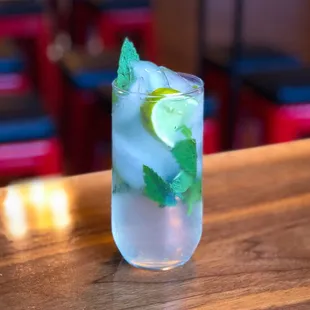 a drink with ice and mint