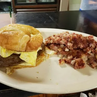 sausage, whipped egg, pepper jack cheese on a croissant. with a side of corn beef hash.