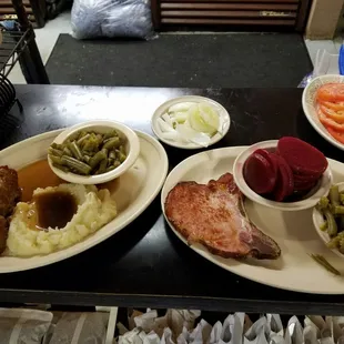 house made meat loaf and smoked pork chop dinner. home made mashed taters, green beans, pickled beets, cucumber n onions