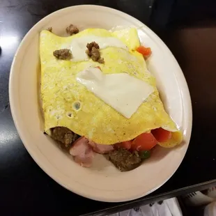 western omelet. 
bacon, ham, sausage, bell peppers, and tomatoes. 
served with toast or biscuit n gravy. 
for only $6.25