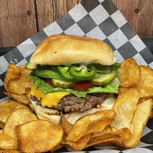 Build your own burger: 1/2lb angus beef patty, American cheese, lettuce, tomato, pickles, avocado and jalapeños, served with chips.