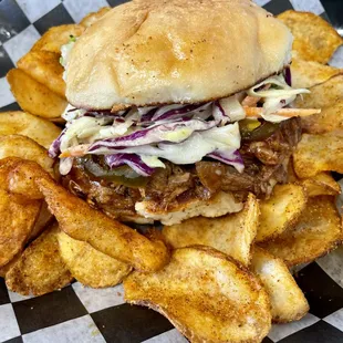 Pulled Pork sandwich loaded with tender pork, bbq sauce, Cajun slaw &amp; candied jalapeños served with house cajun bbq seasoned chips