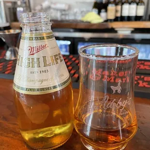 a glass and a bottle of liquor