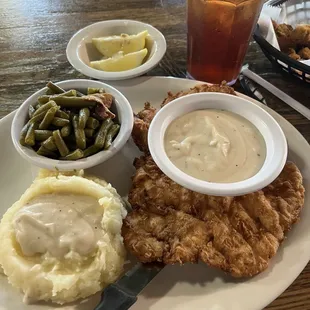 Chicken fried chicken with gravy, real mashed potatoes &amp; gravy with green beans.