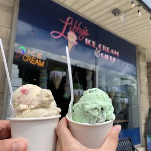 two people holding cups of ice cream