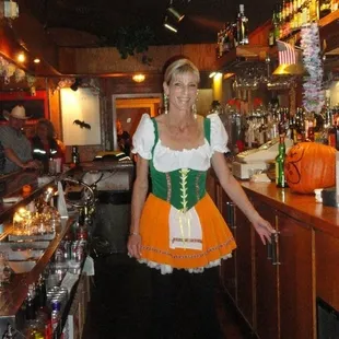 a woman in a bavarian costume at a bar