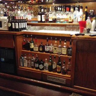a bar with a lot of liquor bottles