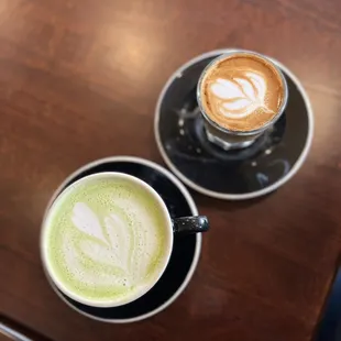 two cups of coffee on a wooden table