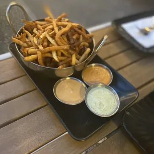 Side of fries with their awesome sauces (Stoop sauce, Cilantro Lime Aioli, and cashew pepper dip)