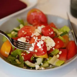 a salad with tomatoes and feta cheese