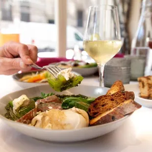 a plate of food and a glass of wine