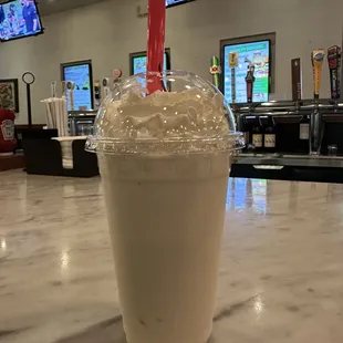 a milkshake in a plastic cup