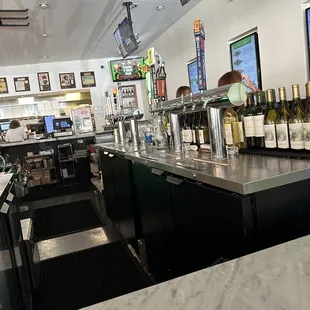 a bar with bottles of wine on the counter