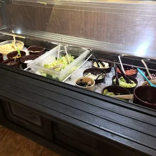 a salad bar with a variety of salads