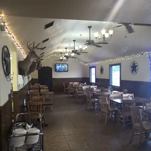 the dining room with a deer head on the wall
