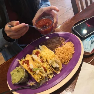 a plate of tacos and salsa