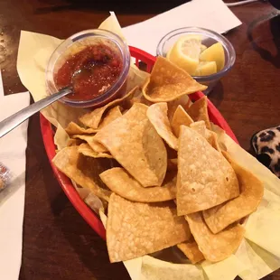 a plate of tortilla chips and a bowl of salsa