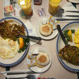 a breakfast of eggs, hash browns, sausage, and vegetables