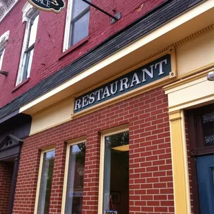 restaurant sign on brick building