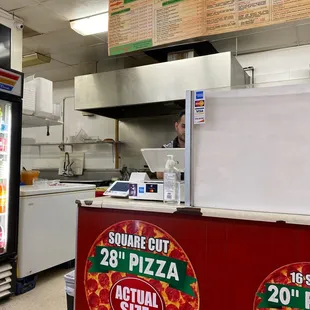 a pizza counter with pizzas on it