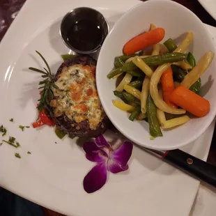 Filet mignon with gorgonzola crusted cheese with vegetable madley. Melted in your mouth