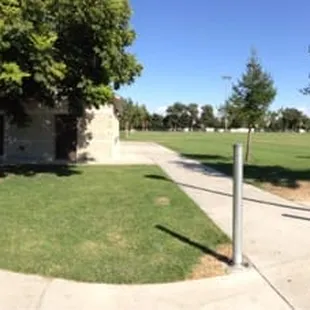 Parking lot, field for sports, basketball court, public restrooms, play yard, also goodwill drop off.