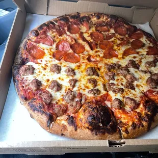 Large half pepperoni half sausage pizza.