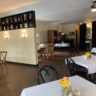 tables and chairs with white tablecloths