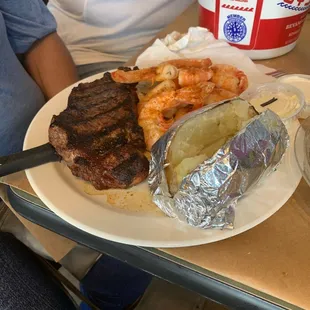 Surf and tuff steak shrimp baked potato