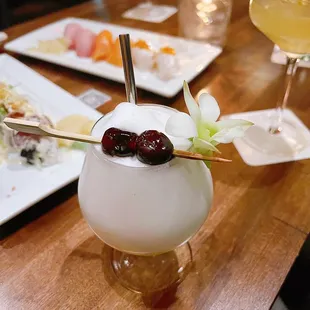 a close up of a cocktail with a garnish on it