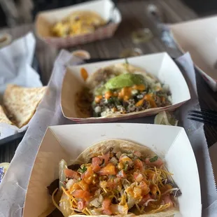 a variety of taco dishes on a table