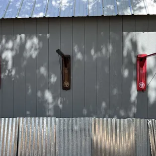 a red fire hydrant on the side of a building