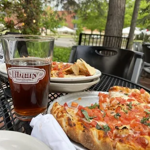 a plate of pizza and a glass of beer
