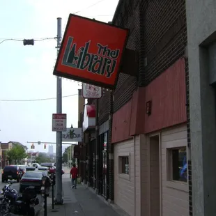 a red and green sign on the side of a building