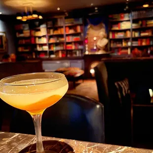 a glass of orange juice on a table