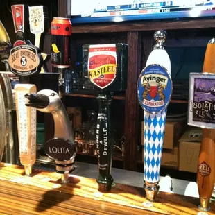 a row of beer taps on a bar