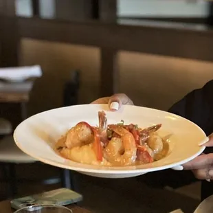 a woman holding a plate of food