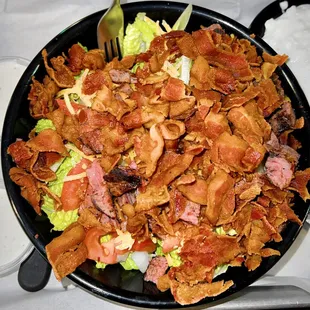 a salad with bacon and lettuce