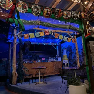 an outdoor bar with lights and decorations