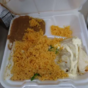 a styrofoam container with rice, beans, and a burrito
