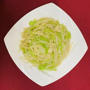 a white plate of food on a red cloth