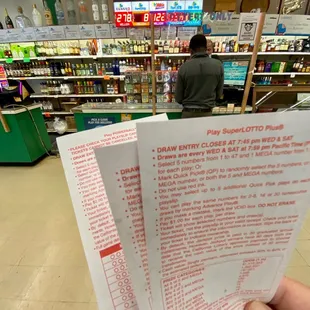 a hand holding a receipt