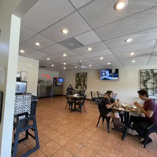 two people sitting at a table in a restaurant