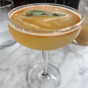 a close up of a cocktail in a coupe glass