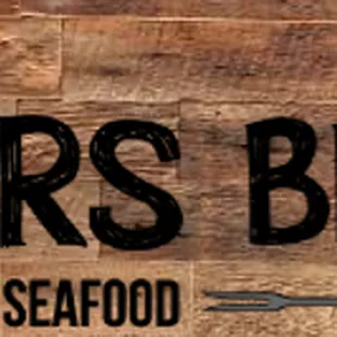 a sign for lickers bbq and seafood