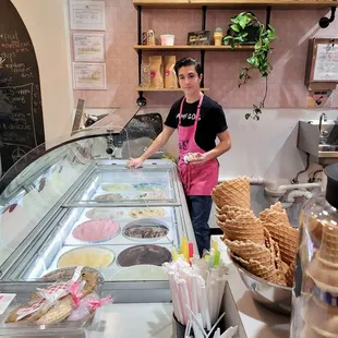 a woman standing behind a counter