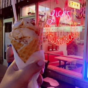 a hand holding an ice cream cone